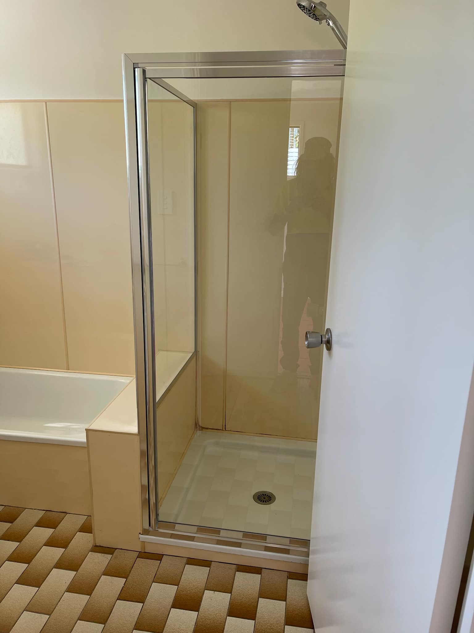 Framed shower screen in a cream bathroom